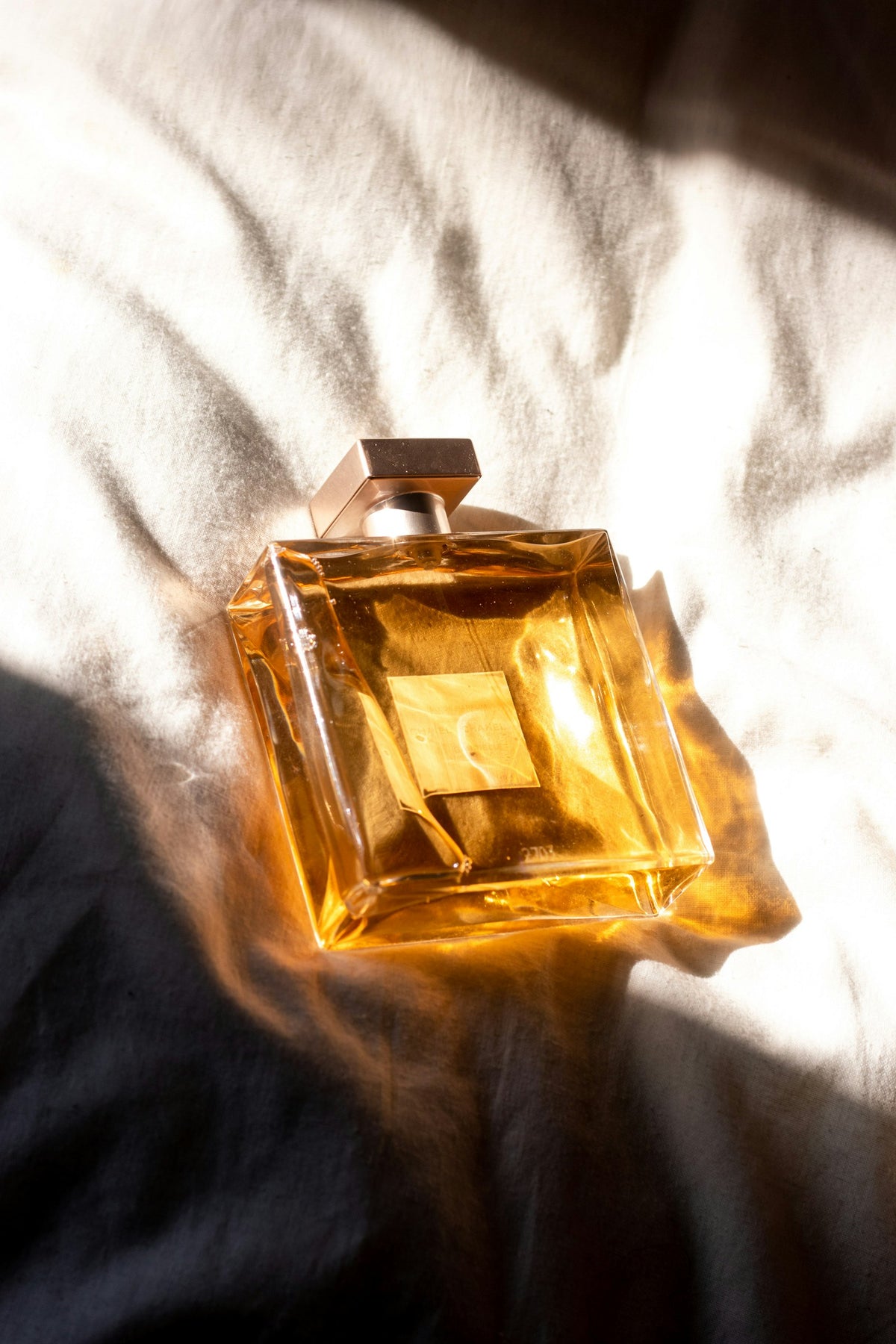 Perfume bottle catching soft golden light on a vanity