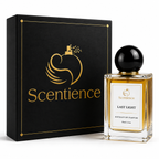 A bottle of Scentience Last Light extrait de parfum displayed beside its black and gold branded gift box on a white studio background.